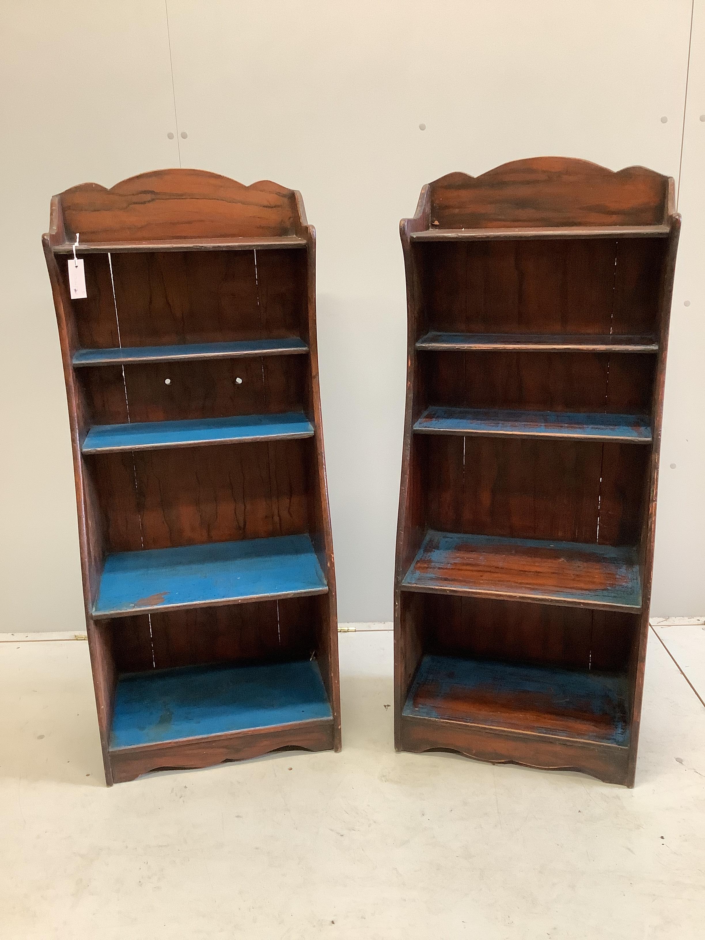 A pair of Regency style painted simulated rosewood narrow open bookcases, width 50cm, depth 31cm, height 124cm